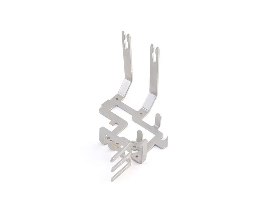 This lead frame for an automotive latch actuator is stamped and insert molded in-house.